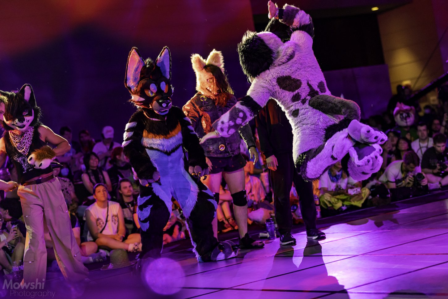 Furries and fursuiters battling each other on the floor during Floor Wars.
